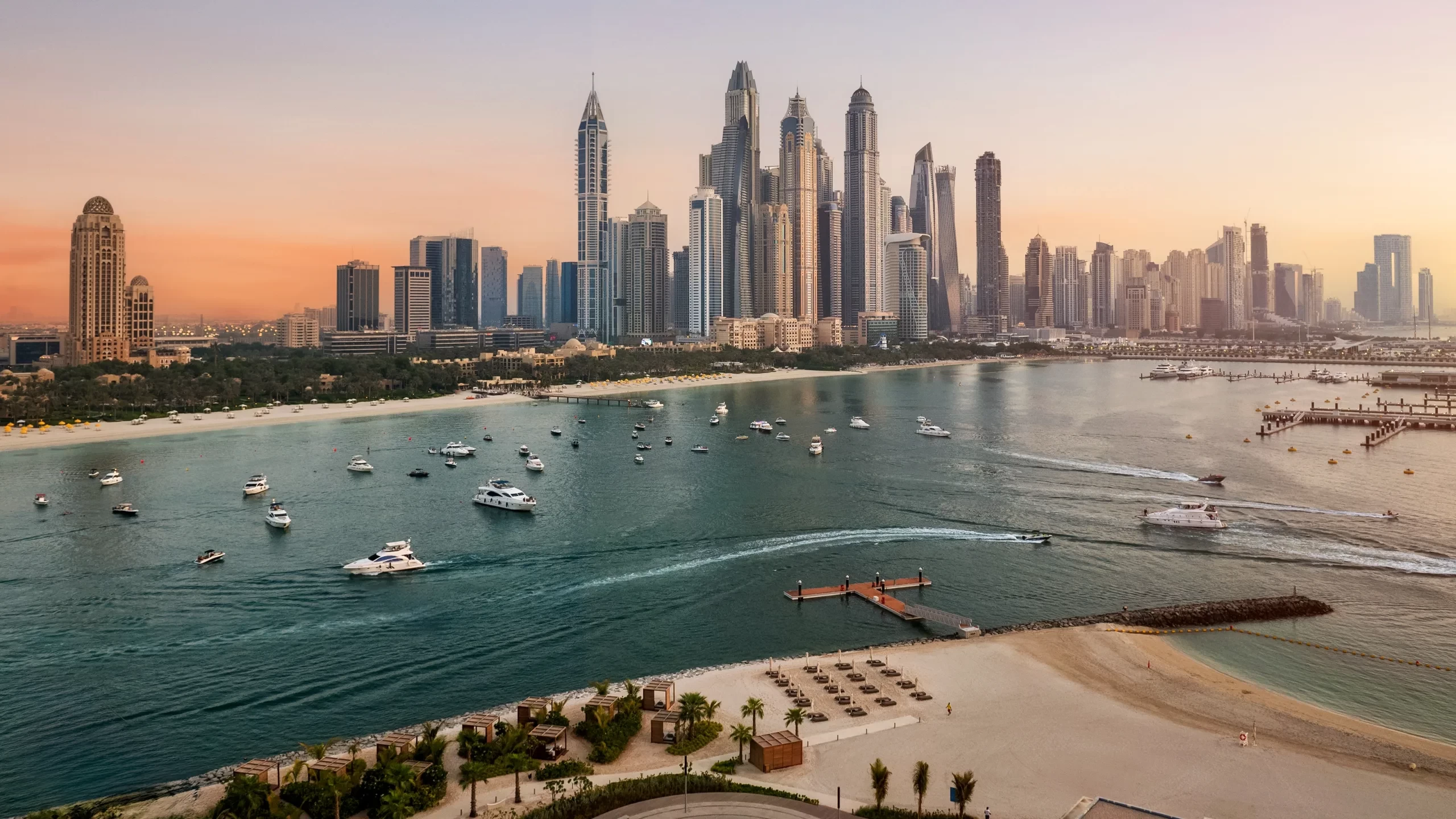 Dubai Marina skyline featuring luxury skyscrapers, yachts, and waterfront views