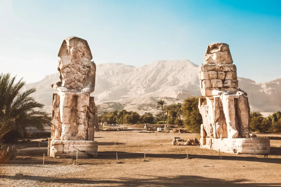 Sunrise view of the Colossi of Memnon statues on the West Bank of Luxor Egypt